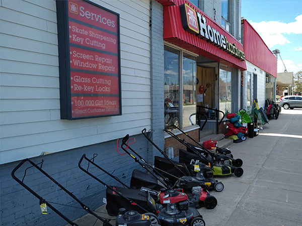 Lawnmowers displayed on the sidewalk in front of Dundalk Home Hardware store.