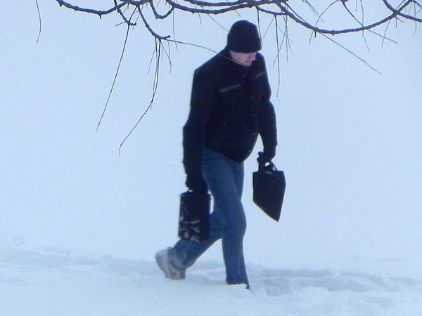 Pilot walks to shore from crashed plane.