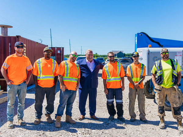 Ontario Premier Doug Ford poses with construction workers in Dundalk
