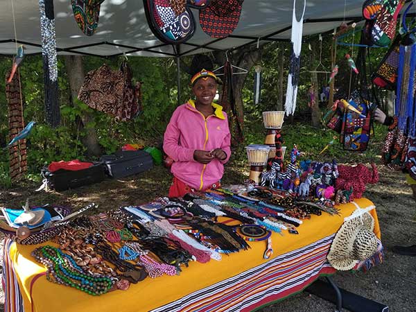 Member of the Neema Choir vending at the market
