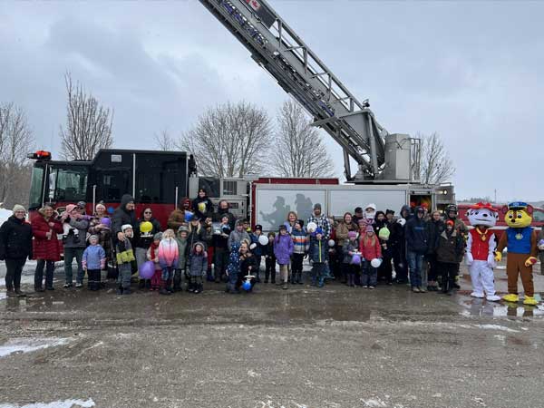 A crowd poses in front of the West Grey fire truck during the egg drop competition