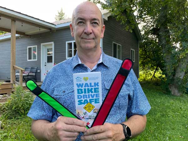 Ron Barnett with road safety arm bands and brochures