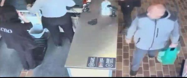 male bald suspect carrying green bag