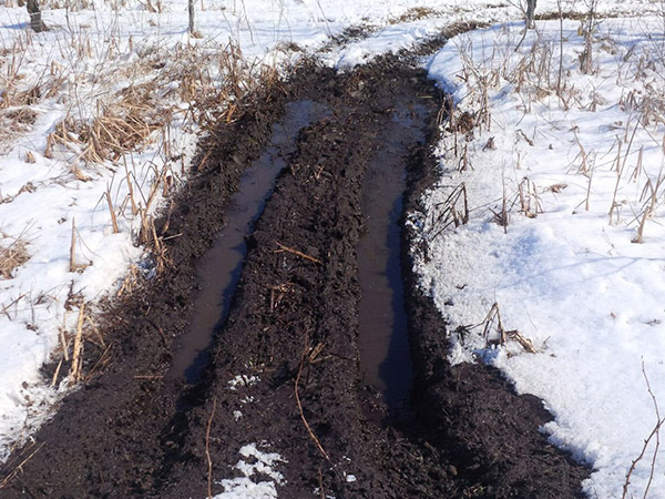 Vehicle damage in muddy area.