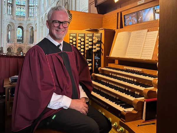 Dr. Gregg Redner seated at pipe organ
